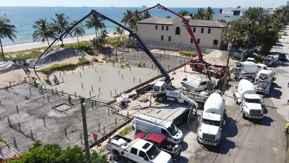 Boom pump on a large oceanfront slab pour, aerial view